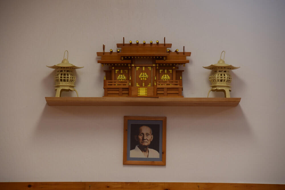 Dojo shrine with lanterns above a portrait of Wado-Ryu founder Hironori Otsuka